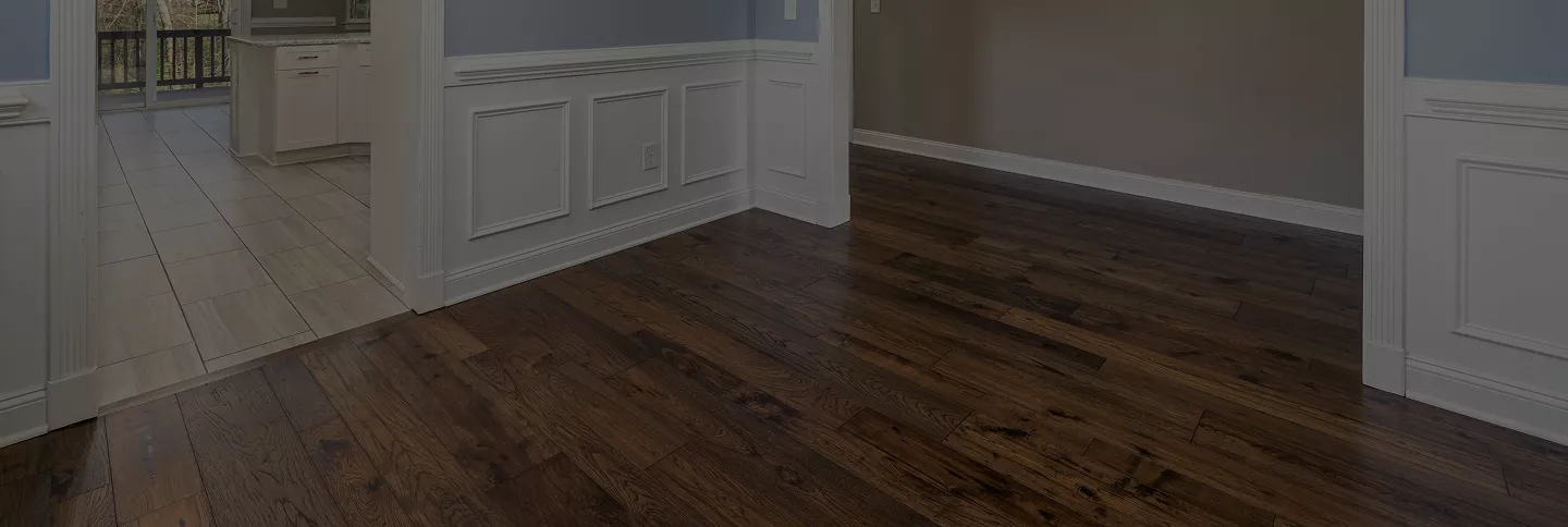 A cozy living room featuring a couch, coffee table, and an air conditioner on the wall.