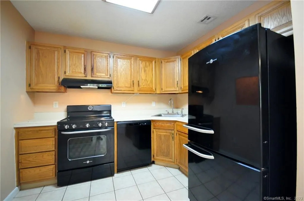 Kitchen with cabinets shown before refinished and is just plain stained wood